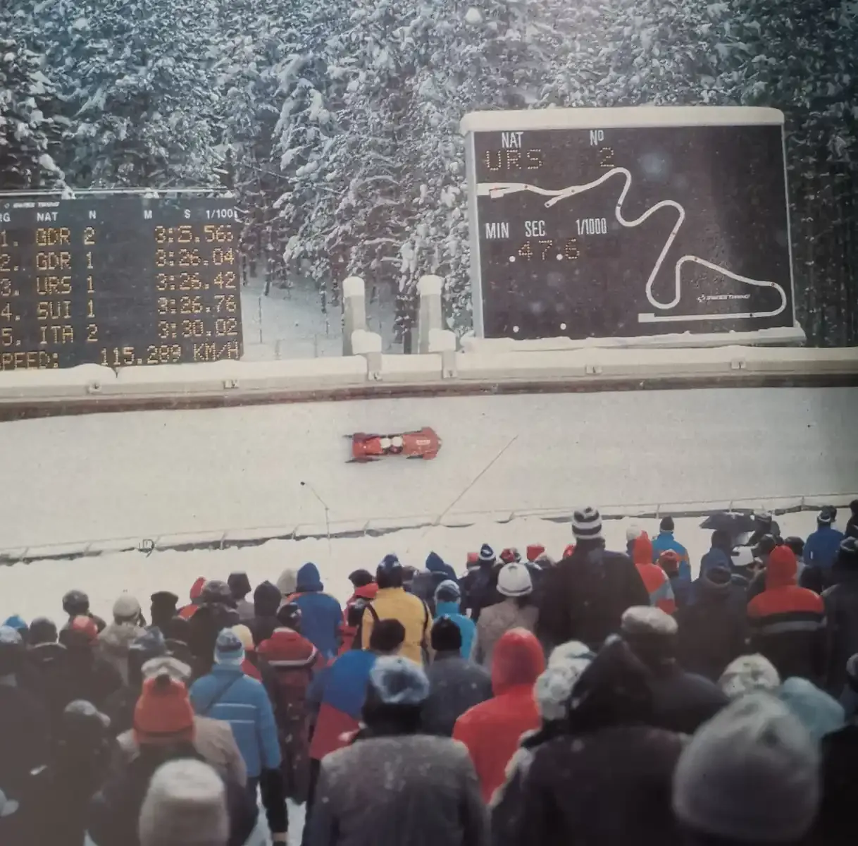 A bobsled speeds past the scoreboard at the Trebević track, 1984
