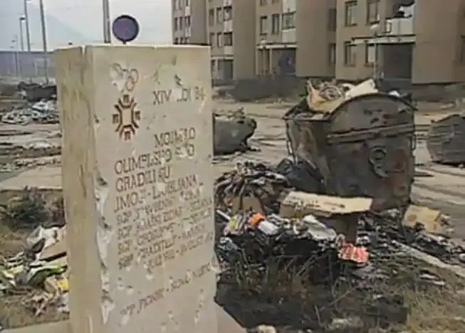 The scarred Mojmilo Olympic Village monument surrounded by debris in 1994.