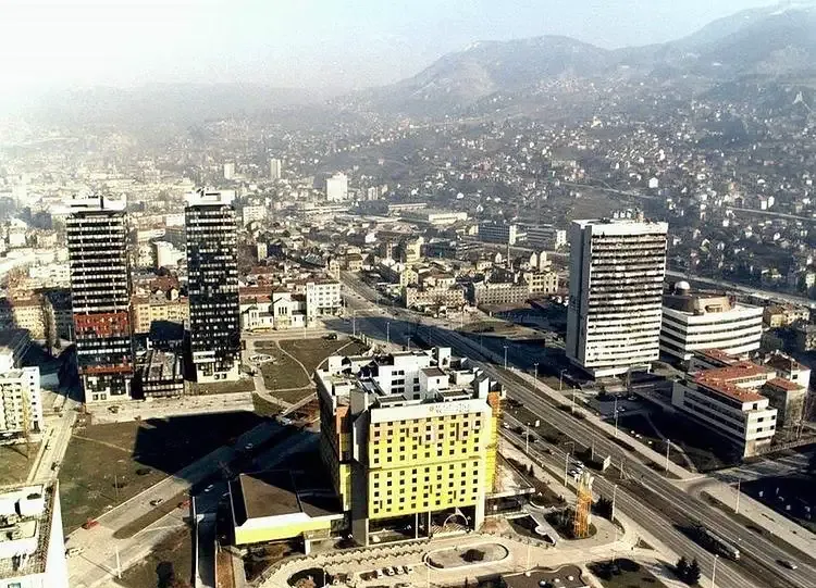 The yellow Hotel Holiday Inn overlooks the Sarajevo cityscape in 1995