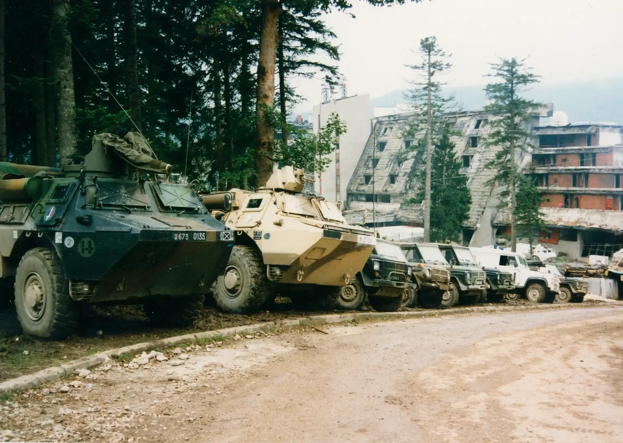 UN military vehicles parked before the ruined Hotel Igman, 1995