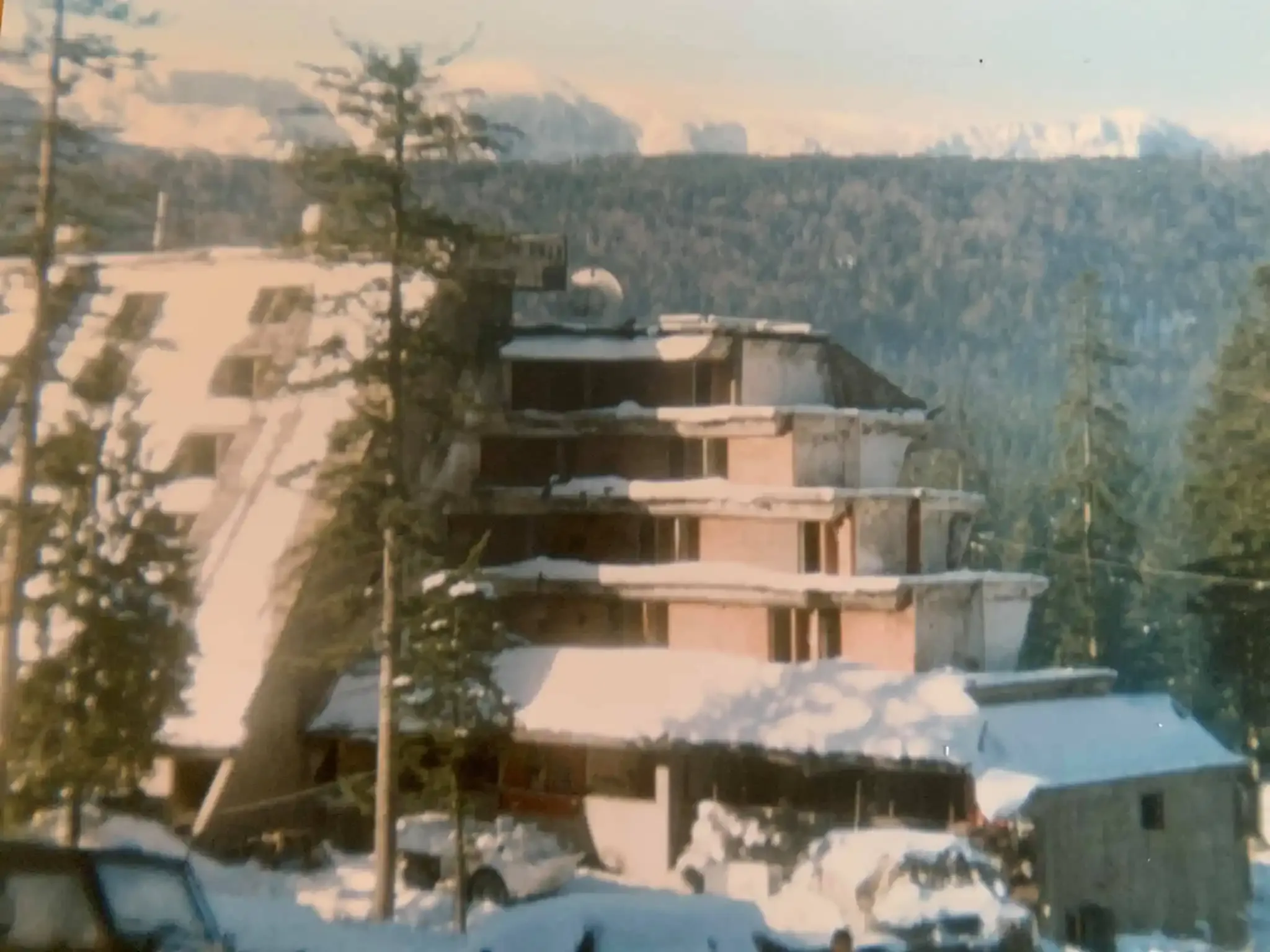 The charred remains of Hotel Igman amidst winter snow, 1995