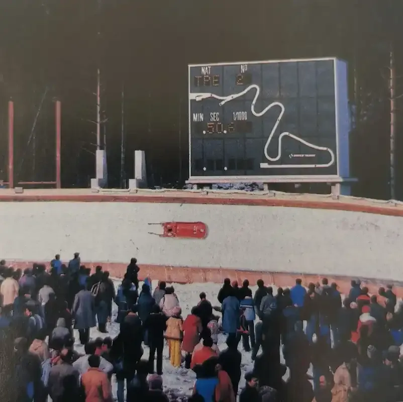 A bobsled rounds a curve at the 1984 Sarajevo Winter Olympics