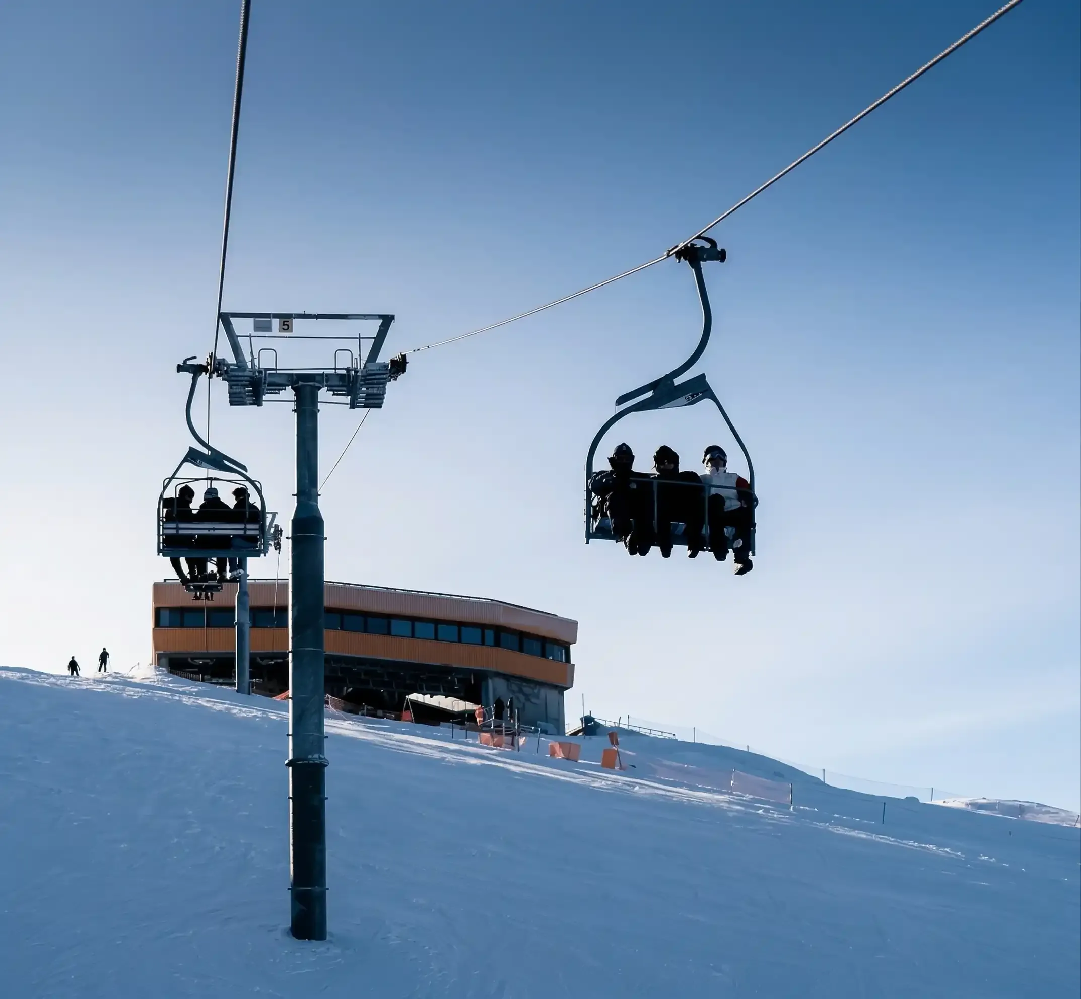 Skiers ascending to the Bjelašnica summit on a three-seater chairlift, 1980s.