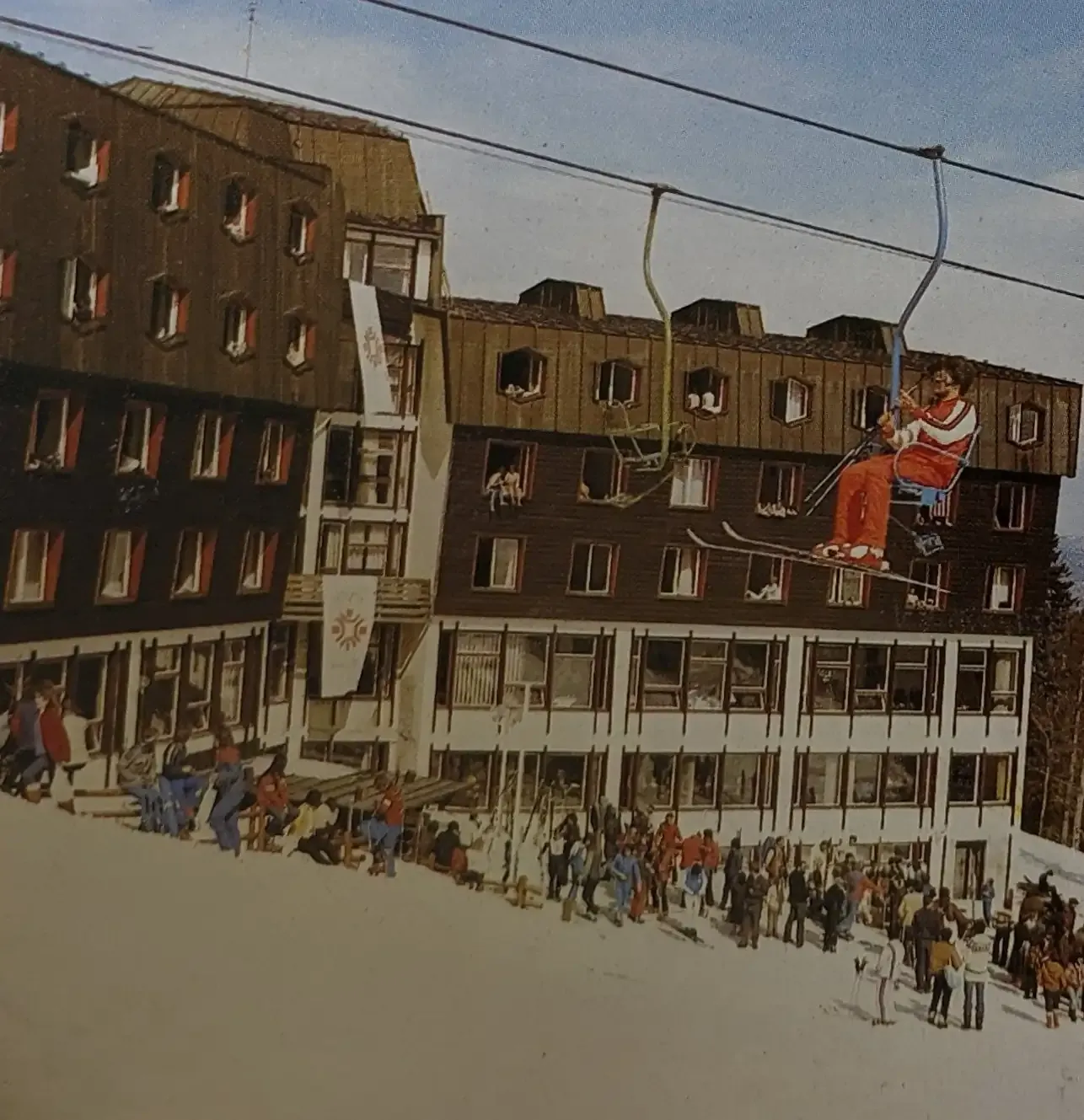 A skier passes Hotel Jahorina during the 1984 Winter Olympics era