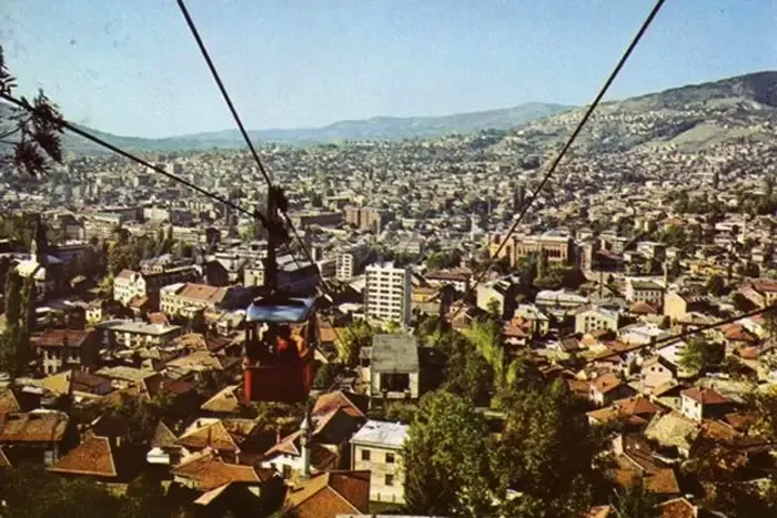 A red Trebević cable car cabin overlooking Sarajevo in the 1970s