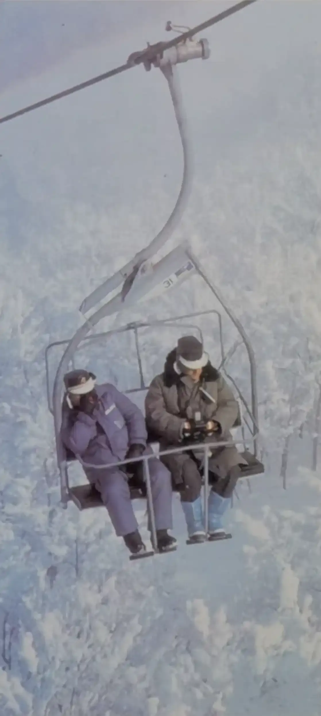 Passengers ride the three-seater chairlift at Bjelašnica during the 1980s.
